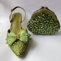 Green embellished shoe and matching handbag on a white background, Obroi