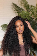 Woman with long, curly hair in a room with plants, Obroi