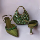 Green beaded shoes and handbag set on a white background, Obroi