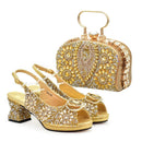 Gold high-heeled shoes and matching clutch bag with intricate designs on a white background, Obroi
