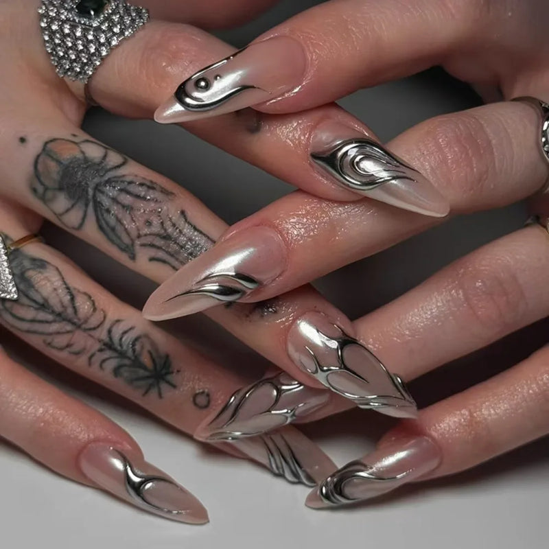 Close-up of hands with silver and black nail art on a neutral background, Obroi
