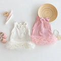 Two children's dresses with bows, a hat, and shoes on a light background, Obroi