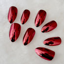 Red metallic nail art designs on a white background, Obroi