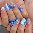 Nails with blue and pink designs on a hand, Obroi