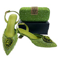 Green high-heeled shoes and matching clutch on a white background, Obroi