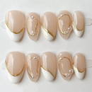 Ten almond-shaped press-on nails arranged in two rows on clear display stands against a white background. The nails have a glossy nude-beige top with a white French tip and decorative gold curved lines and small pearl accents, Obroi
