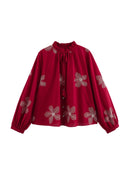 Red blouse with floral patterns on a white background, Obroi