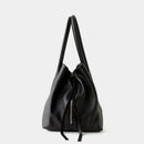 Black leather handbag with a drawstring on a light gray background, featuring the brand 'Obroi'.