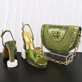 Green high-heeled shoes and matching handbag with rhinestone details on a black surface, Obroi