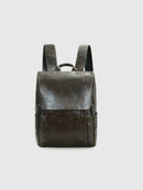 Dark brown leather backpack with cowhide leather detail on a light gray background, featuring the brand 'Obroi'.