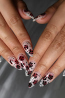 Nails with floral and polka dot design on a neutral background, Obroi