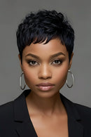 Woman with short black hair wearing hoop earrings against a gray background, Obroi