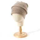 Beige knitted beanie on a mannequin head against a white background, Obroi