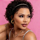 Woman with styled hair and jewelry against a pink background, Obroi