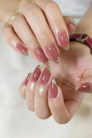 Close-up of hands showcasing a glossy almond-shaped nail manicure in a dusty rose pink color with a sparkling gold French tip accent, Obroi