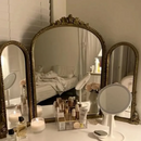 Vintage-style vanity mirror set with various items on a table, Obroi