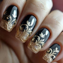 Black nails with gold floral designs on a blurred background, Obroi