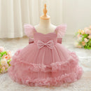 Pink children's dress with a bow on a mannequin against a soft background, Obroi