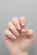 Hand with pink nail polish on a gray background, Obroi