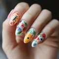 Nails with colorful floral and insect designs on a neutral background, Obroi