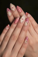 Nails with floral and feather design on a dark background, Obroi