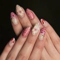 Nails with floral and feather design on a dark background, Obroi