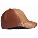 A structured baseball cap made of two-tone leather in medium brown and light tan, shown from a side profile on a white background, Obroi