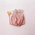 Pink baby romper with floral collar on a light pink background, Obroi