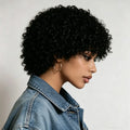 Woman with curly hair wearing a denim jacket against a neutral background, Obroi