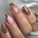 Close-up of a hand with brown and pink nail polish on a neutral background, Obroi