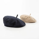 Two berets, one black and one beige, on a white background, Obroi