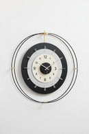 Modern wall clock with black and white design on a light gray background, Obroi
