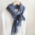 Blue scarf draped over a mannequin against a white background, Obroi