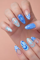 Nails with blue and white floral, checkered, and abstract designs on a light background, Obroi