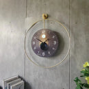 Modern wall clock with gold frame on a concrete wall, Obroi