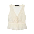 An off-white sleeveless crinkle blouse with a lace-trimmed V-neckline, tie-front detail, and a ruffled peplum hem, shown flat on a white background, Obroi