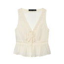 An off-white sleeveless crinkle blouse with a lace-trimmed V-neckline, tie-front detail, and a ruffled peplum hem, shown flat on a white background, Obroi