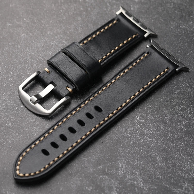 Obroi Black leather watch strap with silver buckle on a gray background