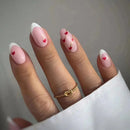 Hand with pink nails with heart designs on a neutral background, Obroi