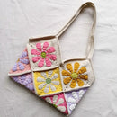 Crocheted bag with colorful flower patterns on a light gray background, Obroi