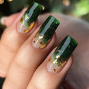 Close-up of a hand with green and gold nail art on a blurred natural background, Obroi