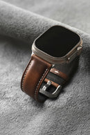 Smartwatch with a brown leather strap on a gray surface, Obroi