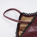 Close-up of a burgundy leather handbag with black lace detailing on a white background, Obroi