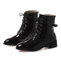 Black patent leather boots with laces on a white background, Obroi