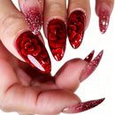 Close-up of a hand with red floral nail art on a white background, Obroi