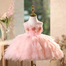 Pink dress on a mannequin with a blurred decorative background, Obroi