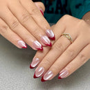 Close-up of hands with red and white nail polish on a neutral background, Obroi