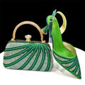 Green handbag and high-heeled shoe with rhinestone details on a black background, Obroi