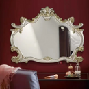 Decorative mirror with gold frame on a red wall, Obroi