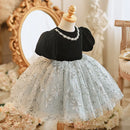 Mannequin wearing a black top and light blue floral skirt with decorative elements, Obroi